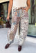 Make room in your denim lineup for these statement-making barrel jeans from Risen. Designed with a neutral mixed paisley print, they bring a vintage-inspired twist to the barrel silhouette you already love. The high-rise fit and cropped length create a flattering shape, while the tie waistband adds an unexpected detail that makes this pair stand out from traditional denim. 