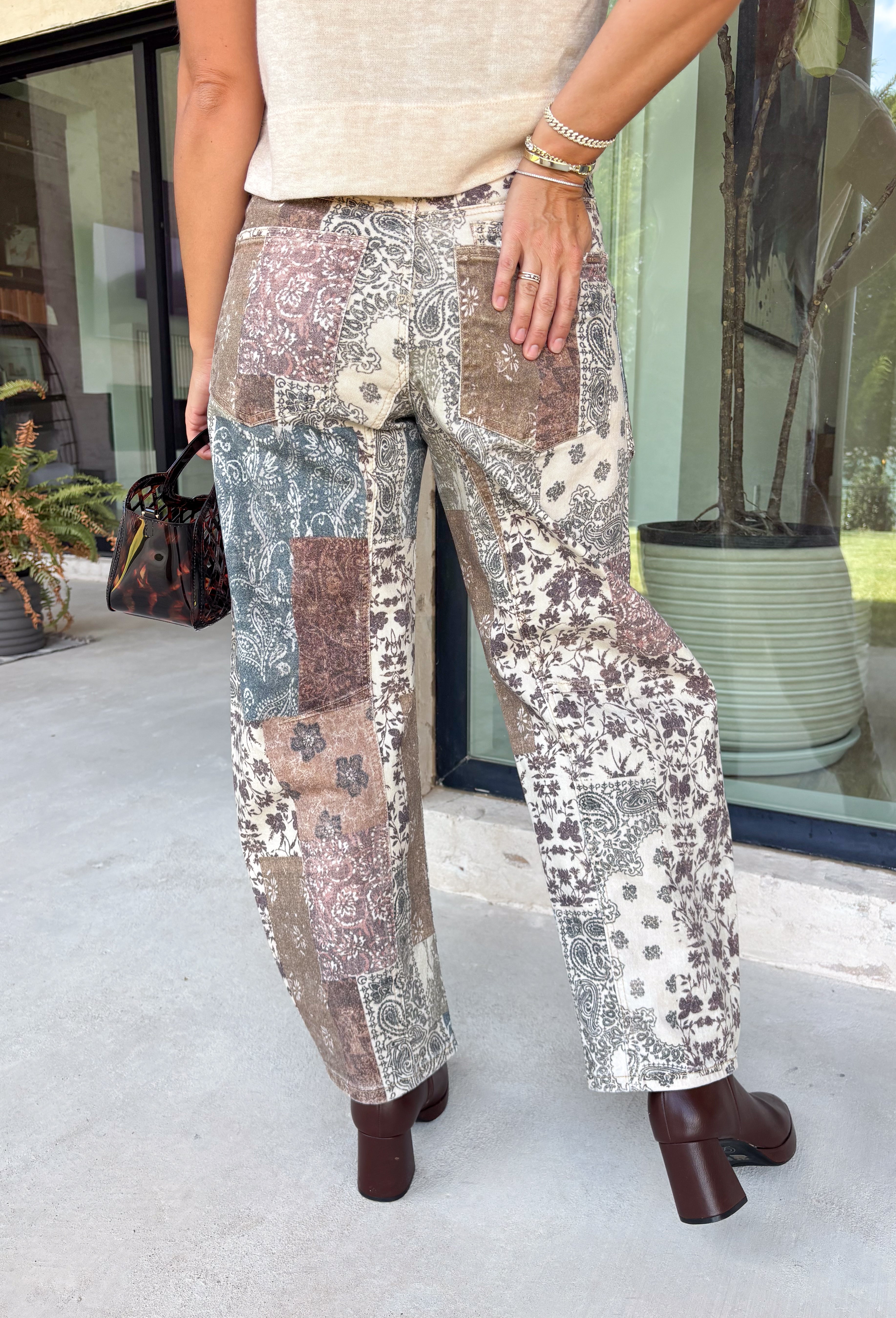 Make room in your denim lineup for these statement-making barrel jeans from Risen. Designed with a neutral mixed paisley print, they bring a vintage-inspired twist to the barrel silhouette you already love. The high-rise fit and cropped length create a flattering shape, while the tie waistband adds an unexpected detail that makes this pair stand out from traditional denim. 