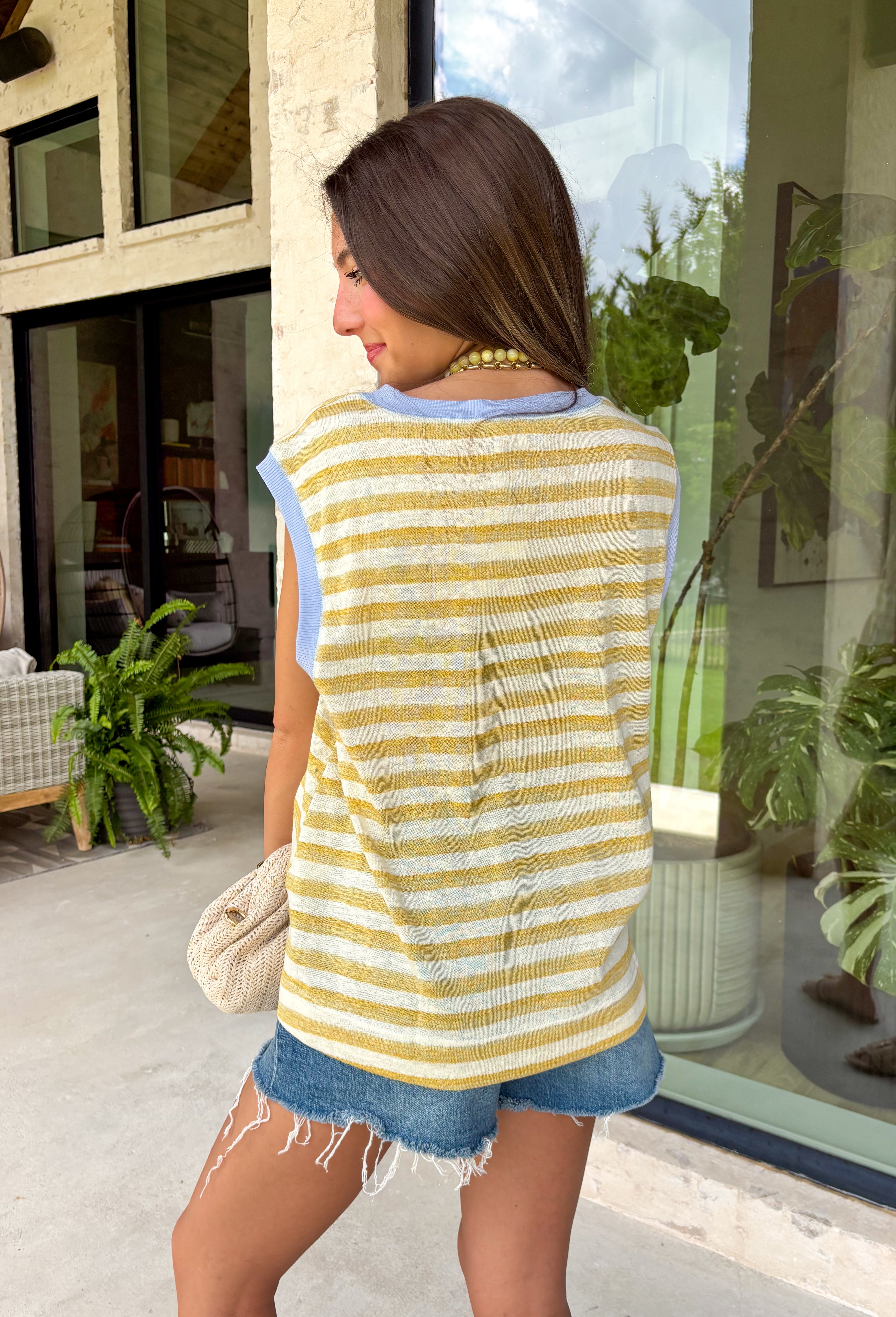 This neutral and mustard stripe top is such a fresh, easy piece for summer! The soft stripe pattern keeps it classic, while the light blue trim along the neckline and sleeves adds the perfect unexpected pop of color. The subtle cap sleeve gives just a little coverage while still keeping it cool and breezy for warm days. Lightweight and easy to style, this is one of those tops you can throw on with denim shorts or white jeans and instantly feel put together. 