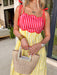 If summer were a dress, this would be it! This sleeveless midi is bursting with cheerful color and playful detail. The pink and red striped bodice features a scalloped neckline that adds the sweetest feminine touch, while the adjustable self-tie straps let you customize the fit just the way you like. The yellow and white skirt brings a bold, sunshine-inspired contrast that feels fresh and fun. 