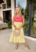 If summer were a dress, this would be it! This sleeveless midi is bursting with cheerful color and playful detail. The pink and red striped bodice features a scalloped neckline that adds the sweetest feminine touch, while the adjustable self-tie straps let you customize the fit just the way you like. The yellow and white skirt brings a bold, sunshine-inspired contrast that feels fresh and fun. 