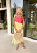 If summer were a dress, this would be it! This sleeveless midi is bursting with cheerful color and playful detail. The pink and red striped bodice features a scalloped neckline that adds the sweetest feminine touch, while the adjustable self-tie straps let you customize the fit just the way you like. The yellow and white skirt brings a bold, sunshine-inspired contrast that feels fresh and fun. 