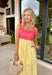 If summer were a dress, this would be it! This sleeveless midi is bursting with cheerful color and playful detail. The pink and red striped bodice features a scalloped neckline that adds the sweetest feminine touch, while the adjustable self-tie straps let you customize the fit just the way you like. The yellow and white skirt brings a bold, sunshine-inspired contrast that feels fresh and fun. 
