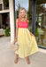 If summer were a dress, this would be it! This sleeveless midi is bursting with cheerful color and playful detail. The pink and red striped bodice features a scalloped neckline that adds the sweetest feminine touch, while the adjustable self-tie straps let you customize the fit just the way you like. The yellow and white skirt brings a bold, sunshine-inspired contrast that feels fresh and fun. 