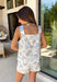 This seashell print two piece set is giving all the coastal summer vibes! The sleeveless white top features a flattering square neckline, while the navy seashell print adds the cutest beachy touch. The matching shorts are just as easy and comfortable with an elastic waistband and adjustable tie for the perfect fit. Made from a lightweight cotton blend, this set is breathable and perfect for warm days—whether you're heading on vacation, running errands, or grabbing lunch by the water. 