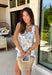 This seashell print two piece set is giving all the coastal summer vibes! The sleeveless white top features a flattering square neckline, while the navy seashell print adds the cutest beachy touch. The matching shorts are just as easy and comfortable with an elastic waistband and adjustable tie for the perfect fit. Made from a lightweight cotton blend, this set is breathable and perfect for warm days—whether you're heading on vacation, running errands, or grabbing lunch by the water. 