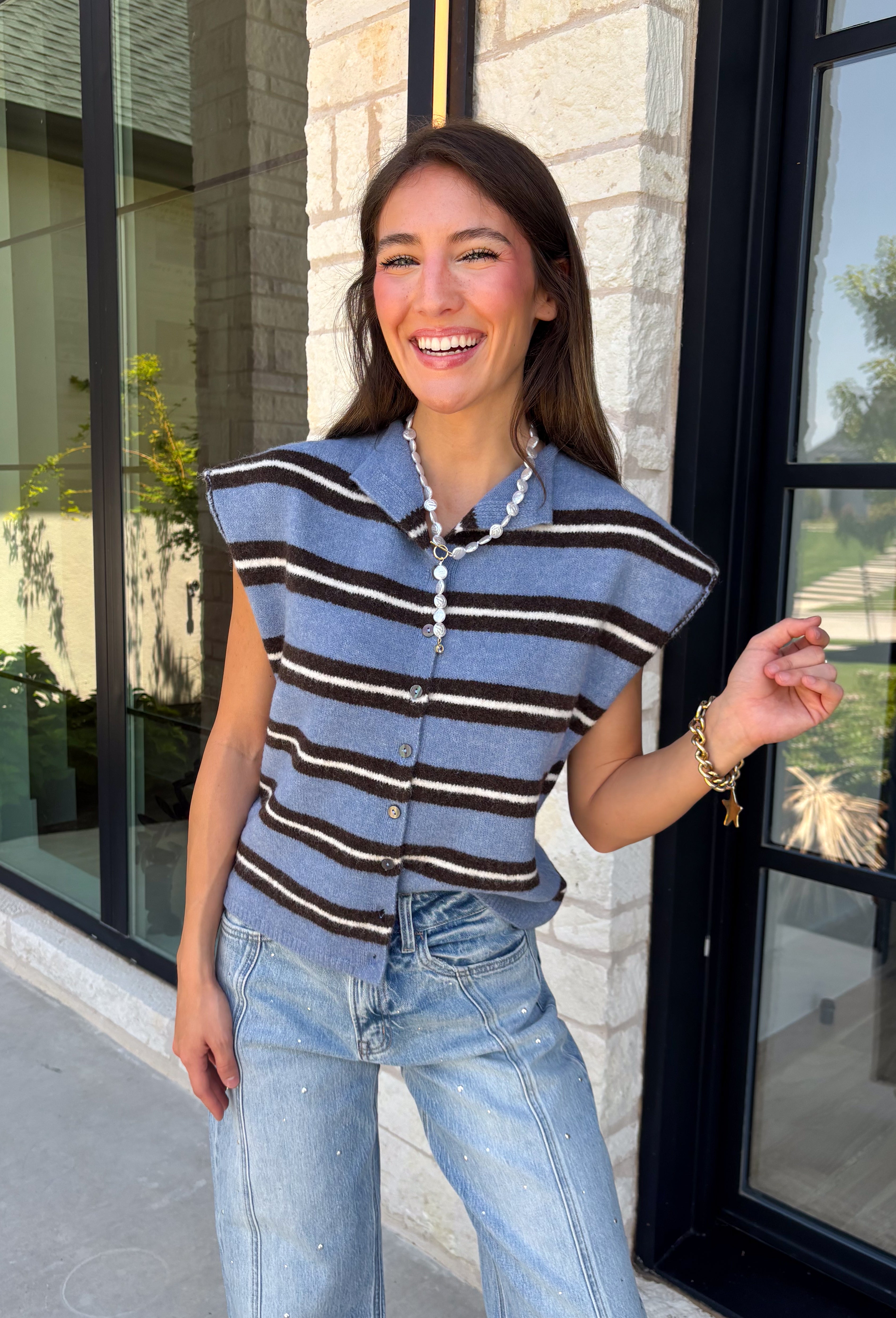 Cozy meets colorful in this sweater cardigan that's made for fall. Featuring a sky blue, black, and crisp white stripes, this soft knit adds the perfect pop of seasonal color to your wardrobe. The button front gives you the option to wear it open as a layering piece or buttoned up as a sweater, making it a versatile staple you'll reach for again and again. Finished with cap sleeves and a cozy knit feel, it's perfect for everything from workdays to weekend coffee dates and all your autumn adventures.