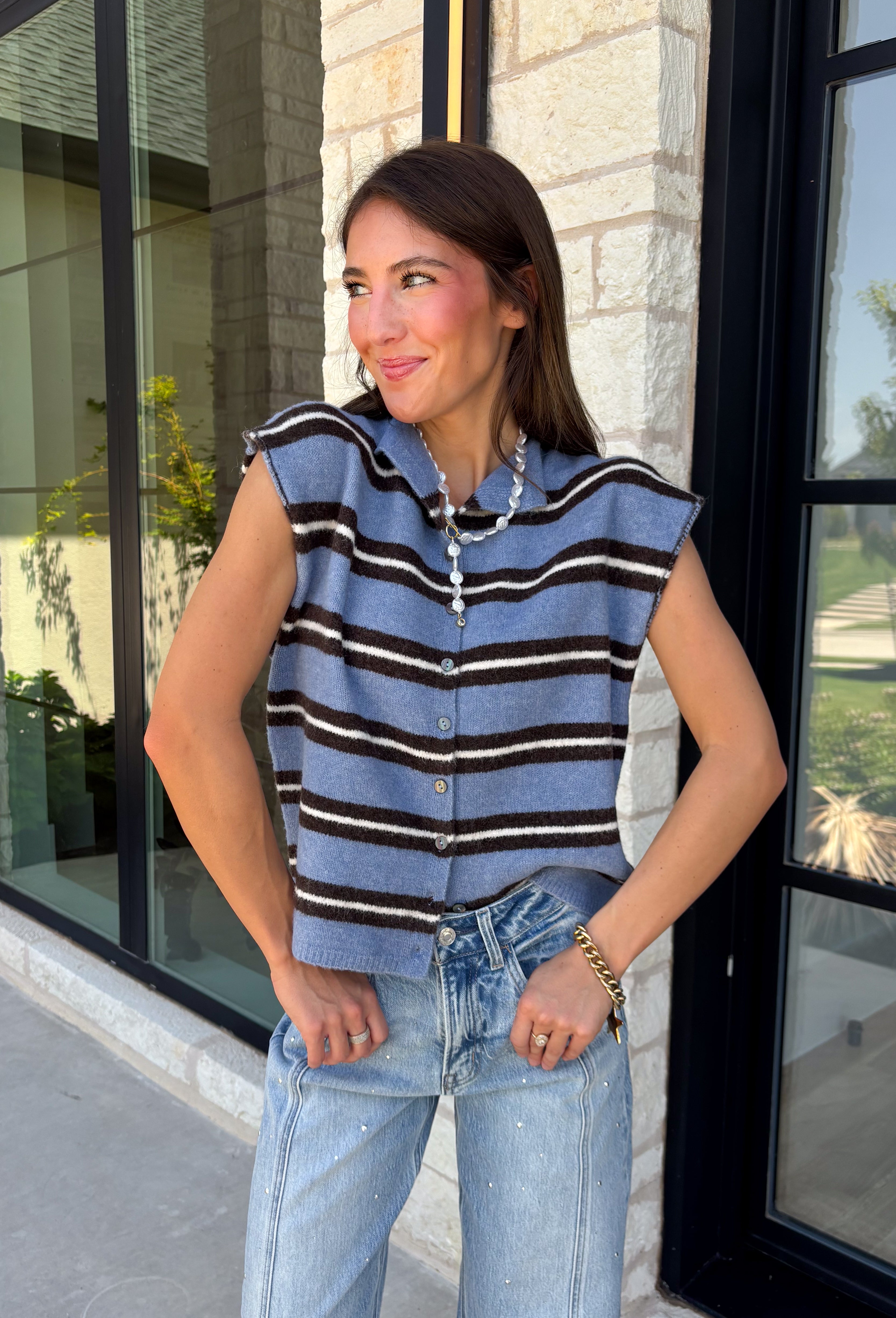Cozy meets colorful in this sweater cardigan that's made for fall. Featuring a sky blue, black, and crisp white stripes, this soft knit adds the perfect pop of seasonal color to your wardrobe. The button front gives you the option to wear it open as a layering piece or buttoned up as a sweater, making it a versatile staple you'll reach for again and again. Finished with cap sleeves and a cozy knit feel, it's perfect for everything from workdays to weekend coffee dates and all your autumn adventures.