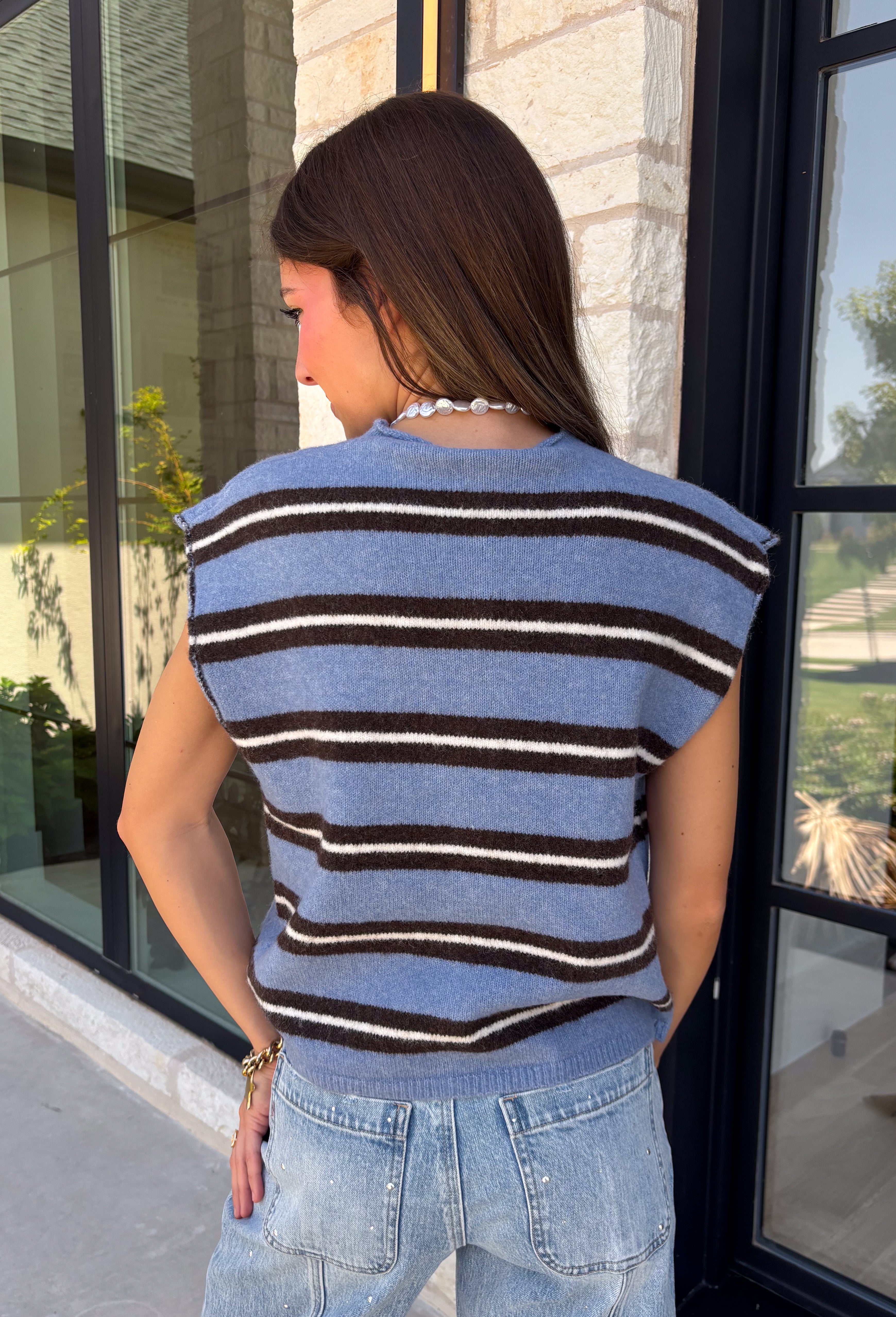Cozy meets colorful in this sweater cardigan that's made for fall. Featuring a sky blue, black, and crisp white stripes, this soft knit adds the perfect pop of seasonal color to your wardrobe. The button front gives you the option to wear it open as a layering piece or buttoned up as a sweater, making it a versatile staple you'll reach for again and again. Finished with cap sleeves and a cozy knit feel, it's perfect for everything from workdays to weekend coffee dates and all your autumn adventures.