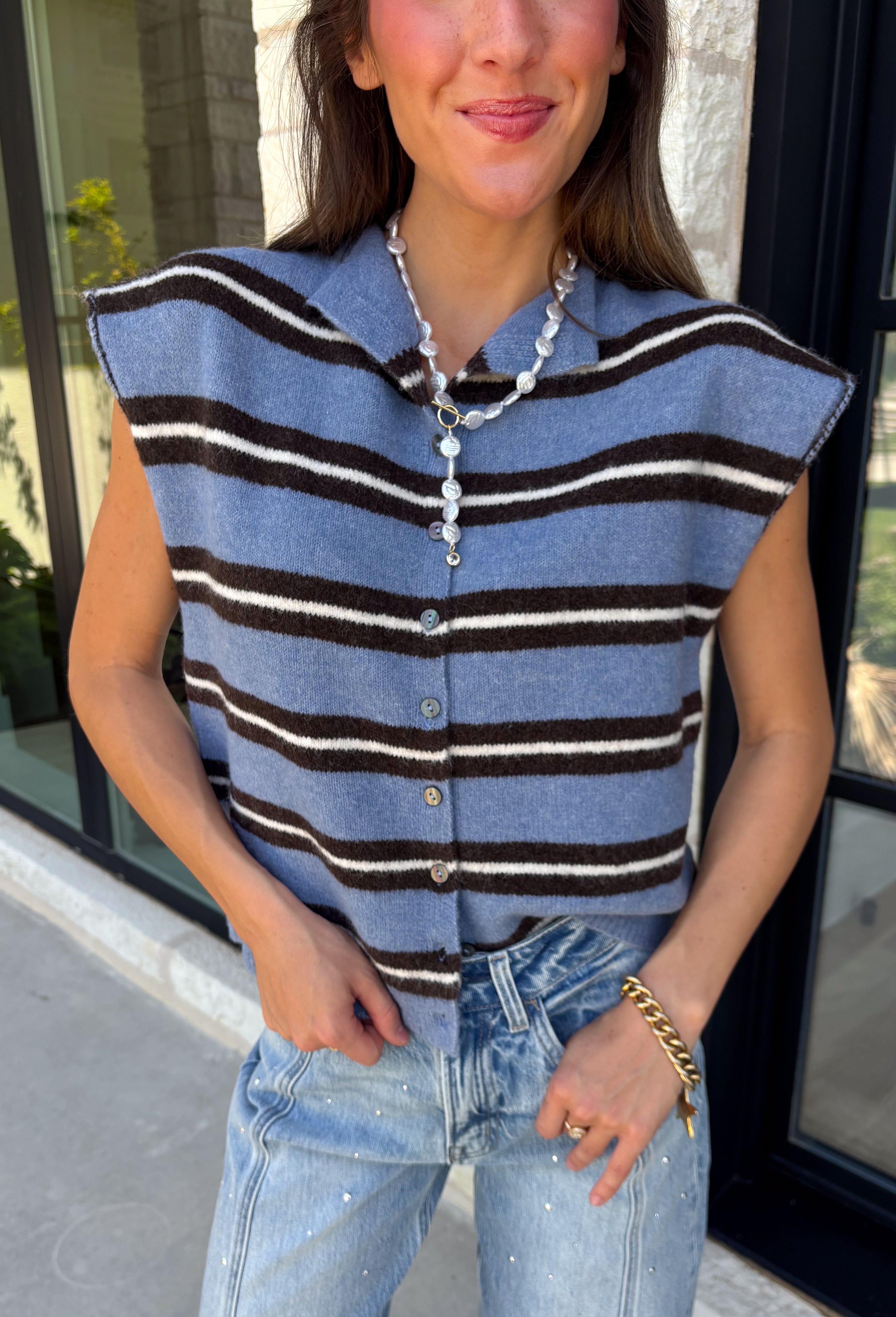 Cozy meets colorful in this sweater cardigan that's made for fall. Featuring a sky blue, black, and crisp white stripes, this soft knit adds the perfect pop of seasonal color to your wardrobe. The button front gives you the option to wear it open as a layering piece or buttoned up as a sweater, making it a versatile staple you'll reach for again and again. Finished with cap sleeves and a cozy knit feel, it's perfect for everything from workdays to weekend coffee dates and all your autumn adventures.