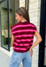 Cozy meets colorful in this sweater cardigan that's made for fall. Featuring rich burgundy, vibrant fuchsia, and crisp white stripes, this soft knit adds the perfect pop of seasonal color to your wardrobe. The button front gives you the option to wear it open as a layering piece or buttoned up as a sweater, making it a versatile staple you'll reach for again and again.