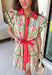 Fresh, feminine, and full of springtime charm, this off white midi dress is blooming with coral, green, and pink florals that instantly brighten your day. The collared neckline and button-down design give it a classic shirt dress feel, while the coral trim and green rick rack detailing along the front, skirt, and sleeves add the sweetest pop of playful contrast. The coral self-tie belt cinches the waist for a flattering silhouette that’s easy to adjust just how you like it.