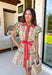 Fresh, feminine, and full of springtime charm, this off white midi dress is blooming with coral, green, and pink florals that instantly brighten your day. The collared neckline and button-down design give it a classic shirt dress feel, while the coral trim and green rick rack detailing along the front, skirt, and sleeves add the sweetest pop of playful contrast. The coral self-tie belt cinches the waist for a flattering silhouette that’s easy to adjust just how you like it.