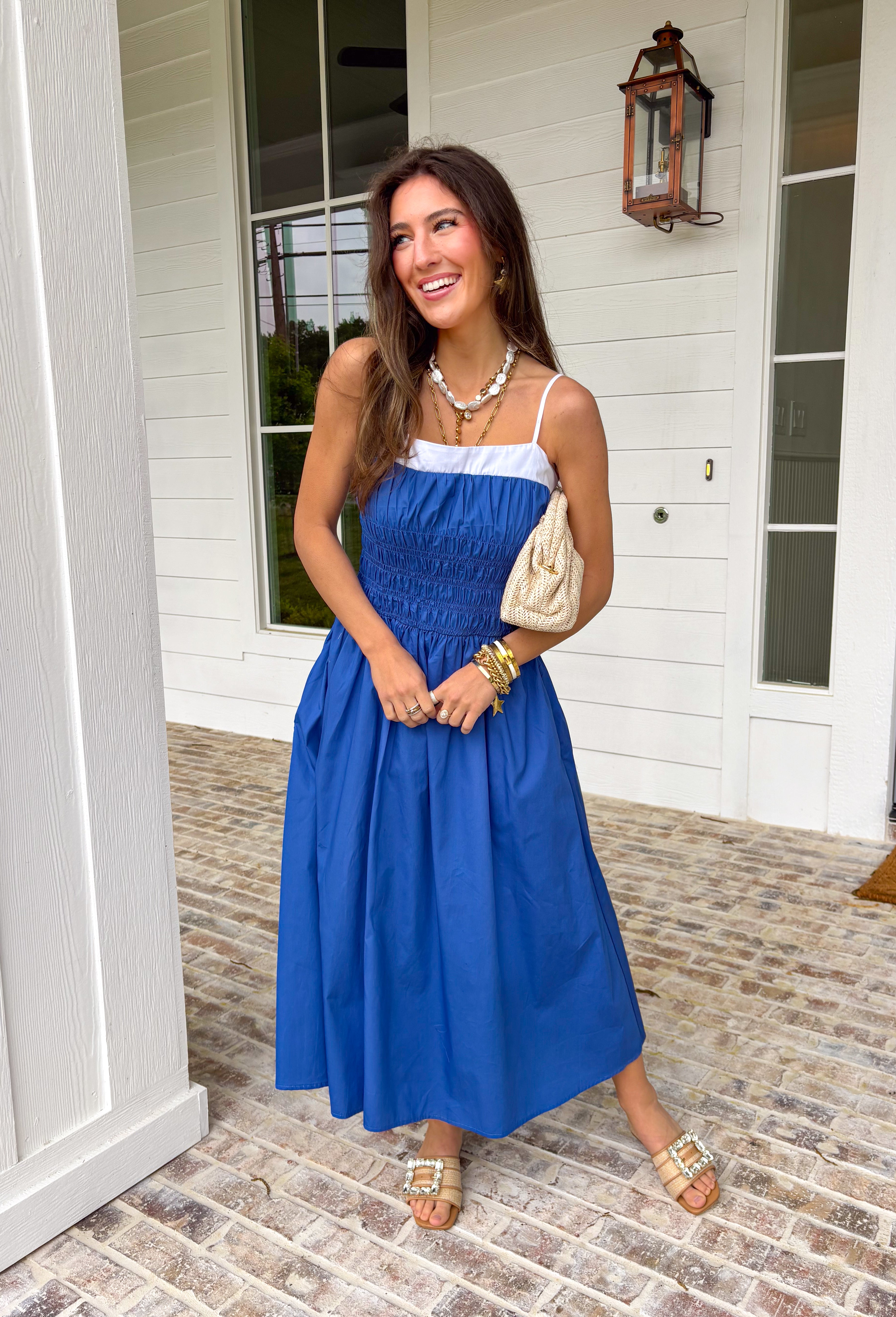 Easy, breezy, and made for sunshine-filled days! This blue sleeveless midi dress features crisp white trim along the top for a fresh pop of contrast that keeps the look clean and classic. Adjustable straps allow you to customize the fit, while smocking at the waist and back creates a flattering shape with comfortable stretch. The lightweight cotton fabric keeps it breathable, and of course it has side pockets — because we know that’s a must. Fully lined for easy wear.