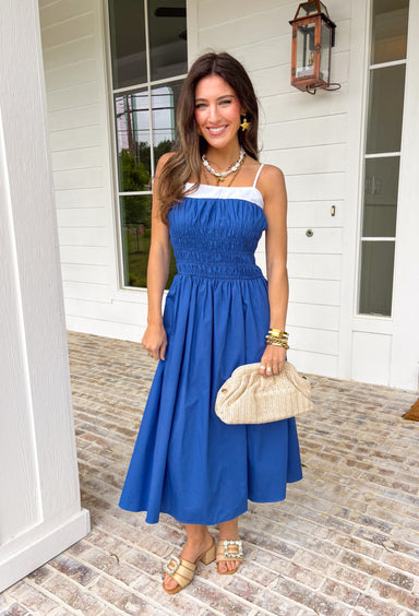 Easy, breezy, and made for sunshine-filled days! This blue sleeveless midi dress features crisp white trim along the top for a fresh pop of contrast that keeps the look clean and classic. Adjustable straps allow you to customize the fit, while smocking at the waist and back creates a flattering shape with comfortable stretch. The lightweight cotton fabric keeps it breathable, and of course it has side pockets — because we know that’s a must. Fully lined for easy wear.