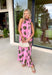Vacation vibes meet spring sweetness in this light pink midi dress by Entro. Featuring a playful green palm print throughout, this dress is made for sunny days, brunch plans, and warm-weather getaways. The halter neckline with a tie detail adds a flirty, feminine touch, while the fully lined design keeps it comfortable and easy to wear. Side pockets make it even better (because functional can still be cute), and the lightweight tencel blend gives it that breezy, elevated feel.
