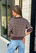 Wrap yourself in effortless fall style with this cozy striped sweater. Featuring a rich brown knit with timeless ivory stripes, this relaxed sweater is the perfect blend of classic and casual. Exposed seam details give it a laid-back feel, while the 3/4-length sleeves make it an easy piece to wear from the first cool mornings of the season through crisp autumn afternoons. Finished with a ribbed neckline, hem, and cuffs, it's a sweater you'll find yourself reaching for again and again.