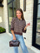 Wrap yourself in effortless fall style with this cozy striped sweater. Featuring a rich brown knit with timeless ivory stripes, this relaxed sweater is the perfect blend of classic and casual. Exposed seam details give it a laid-back feel, while the 3/4-length sleeves make it an easy piece to wear from the first cool mornings of the season through crisp autumn afternoons. Finished with a ribbed neckline, hem, and cuffs, it's a sweater you'll find yourself reaching for again and again.