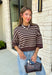 Wrap yourself in effortless fall style with this cozy striped sweater. Featuring a rich brown knit with timeless ivory stripes, this relaxed sweater is the perfect blend of classic and casual. Exposed seam details give it a laid-back feel, while the 3/4-length sleeves make it an easy piece to wear from the first cool mornings of the season through crisp autumn afternoons. Finished with a ribbed neckline, hem, and cuffs, it's a sweater you'll find yourself reaching for again and again.