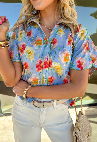 Light, cheerful, and made for sunny days, this light blue button-down top by Umgee is a springtime favorite. Featuring a colorful floral print in shades of green, mustard, and pink, this top brings an easy pop of color to your everyday wardrobe. The collared neckline keeps it classic, while the scalloped sleeves add a sweet, feminine touch that feels perfect for the season.