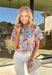 Light, cheerful, and made for sunny days, this light blue button-down top by Umgee is a springtime favorite. Featuring a colorful floral print in shades of green, mustard, and pink, this top brings an easy pop of color to your everyday wardrobe. The collared neckline keeps it classic, while the scalloped sleeves add a sweet, feminine touch that feels perfect for the season.