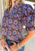 Fresh florals meet rich autumn colors in this beautifully feminine top. Featuring a warm brown backdrop with blooms in shades of blue, purple, and green, this top is an effortless way to brighten your fall wardrobe. The ruffled accent neckline and flattering v-neck add timeless charm, while the short puff sleeves with elastic ruffle cuffs create a soft, romantic silhouette. 