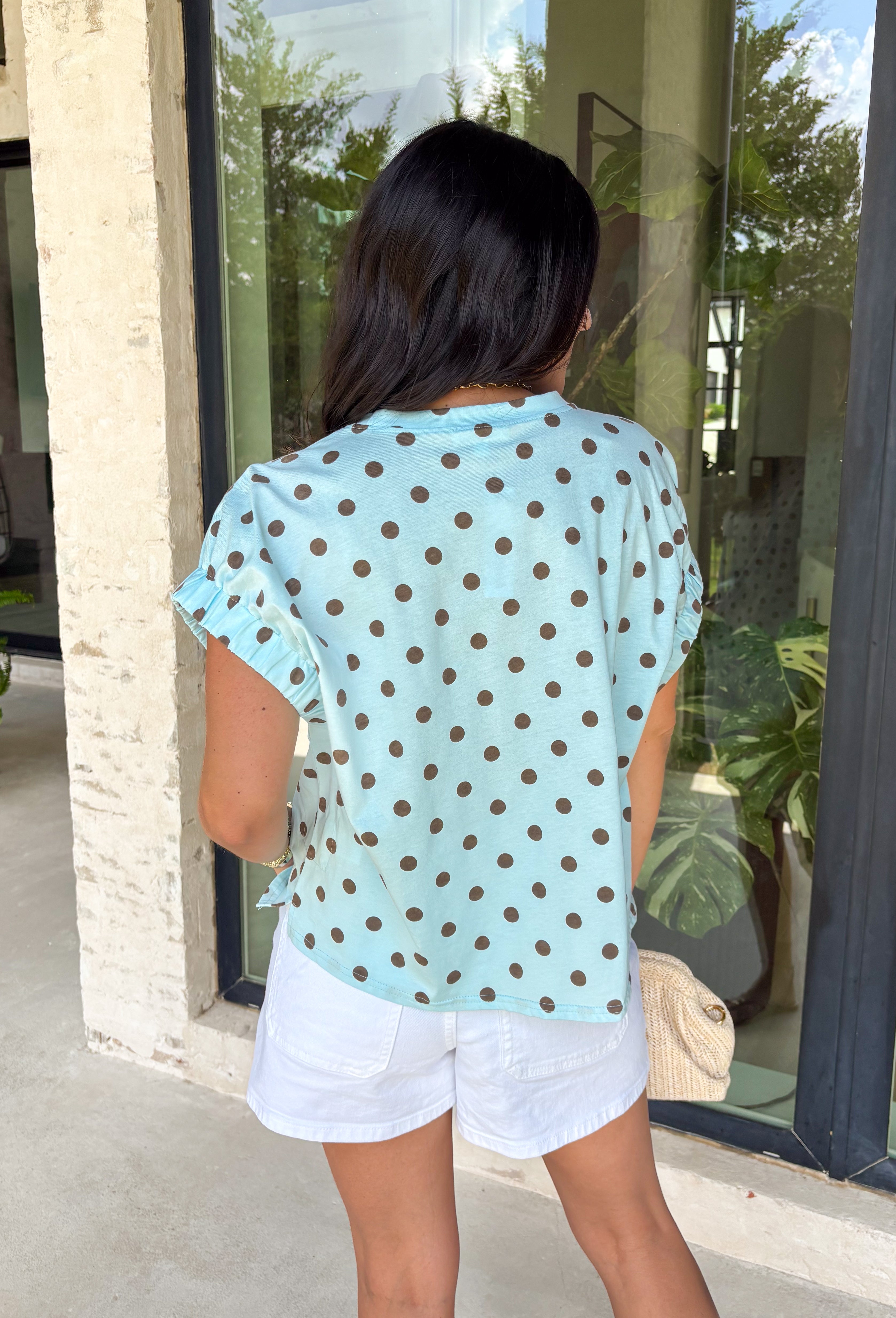 This light blue polka dot top is such a fun twist on a classic summer staple! The soft blue base paired with brown polka dots gives it a playful, slightly unexpected vibe that still feels easy to wear every day. The elastic cuff sleeves create a subtle puff sleeve shape that adds a feminine touch without being over the top. Made from breathable cotton, it’s perfect for warm days when you want something cute and comfortable. 