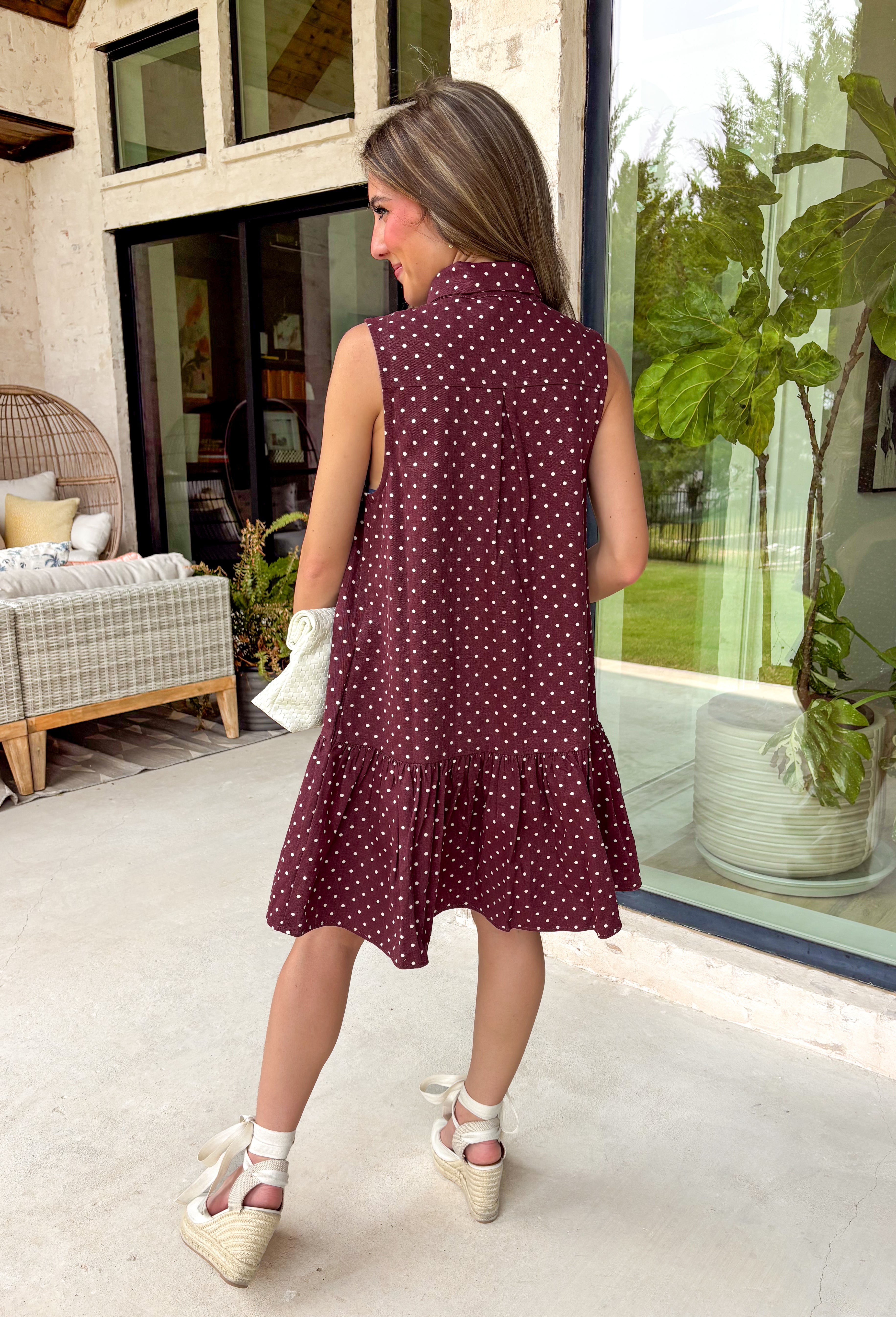 Timeless style meets feminine charm in this adorable mini dress from Entro. Crafted from burgundy denim with a classic off-white polka dot print, this sleeveless dress is full of thoughtful details you'll love. The attached neck tie adds a polished, vintage-inspired touch, while the button-front design creates an effortlessly classic silhouette. Finished with side pockets and breathable cotton fabric, this versatile dress is perfect for everything from brunch dates to weekend adventures all season long.