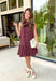 Timeless style meets feminine charm in this adorable mini dress from Entro. Crafted from burgundy denim with a classic off-white polka dot print, this sleeveless dress is full of thoughtful details you'll love. The attached neck tie adds a polished, vintage-inspired touch, while the button-front design creates an effortlessly classic silhouette. Finished with side pockets and breathable cotton fabric, this versatile dress is perfect for everything from brunch dates to weekend adventures all season long.