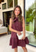Timeless style meets feminine charm in this adorable mini dress from Entro. Crafted from burgundy denim with a classic off-white polka dot print, this sleeveless dress is full of thoughtful details you'll love. The attached neck tie adds a polished, vintage-inspired touch, while the button-front design creates an effortlessly classic silhouette. Finished with side pockets and breathable cotton fabric, this versatile dress is perfect for everything from brunch dates to weekend adventures all season long.