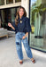 Give your denim collection a fresh twist with this dark wash blouse from Entro. The lightweight cotton fabric keeps it comfortable and easy to wear, while the rich dark wash feels right at home as fall transitions into winter. A high neckline with a self-tie detail adds a pretty focal point, complemented by gold button detailing along the front. The ¾ puff sleeves bring a little volume to the silhouette without making it feel overly dressy. 