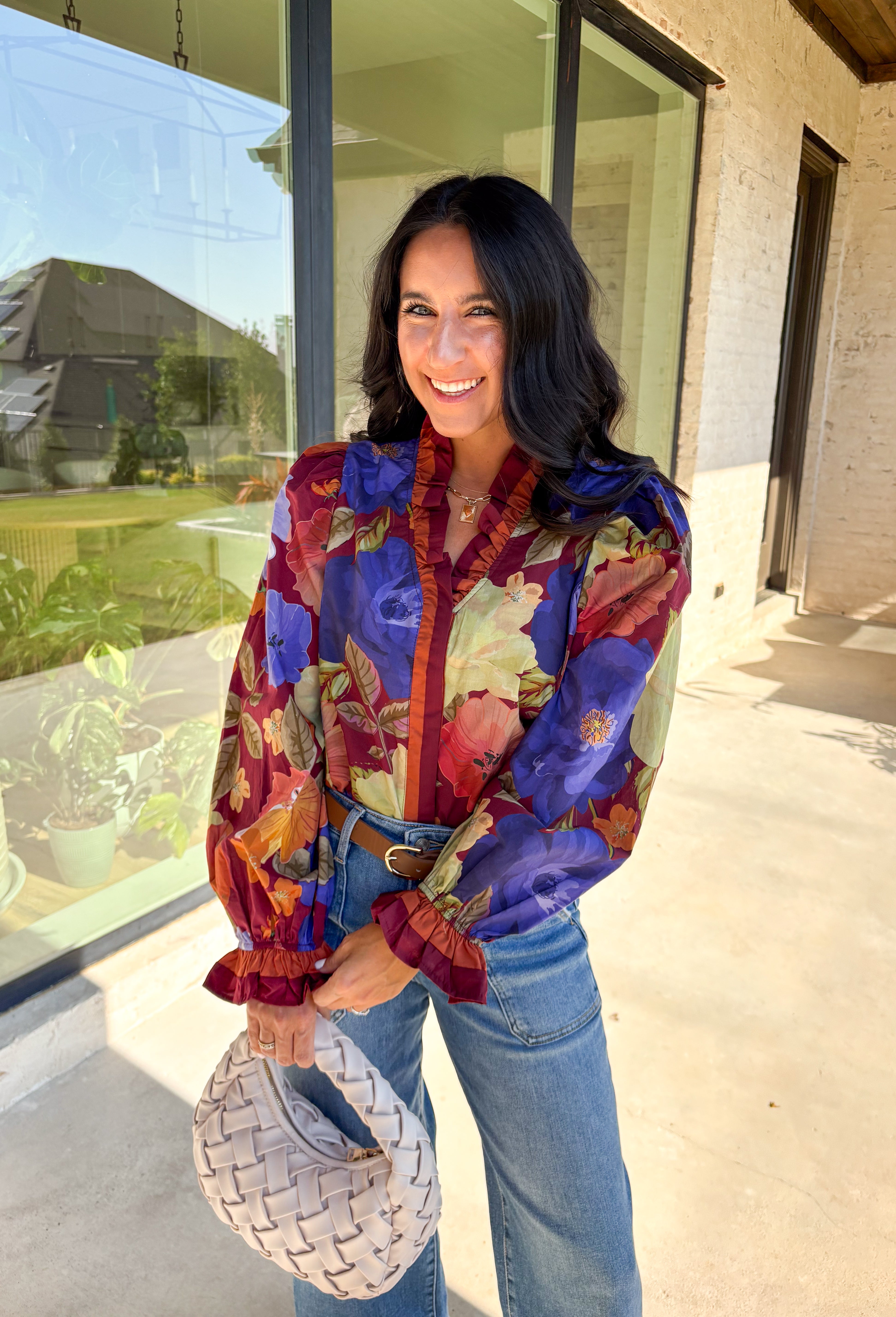 Romantic details make this burgundy floral top a standout for fall. The long sleeves give it an easy, relaxed fit, while the pleated ruffle trim along the neckline and placket adds movement and charm. Designed with a mix of autumn tones in the print, it’s a lightweight piece that’s as versatile as it is stylish. Perfect for workdays, casual weekends, or seasonal gatherings, this blouse transitions seamlessly from day to night.