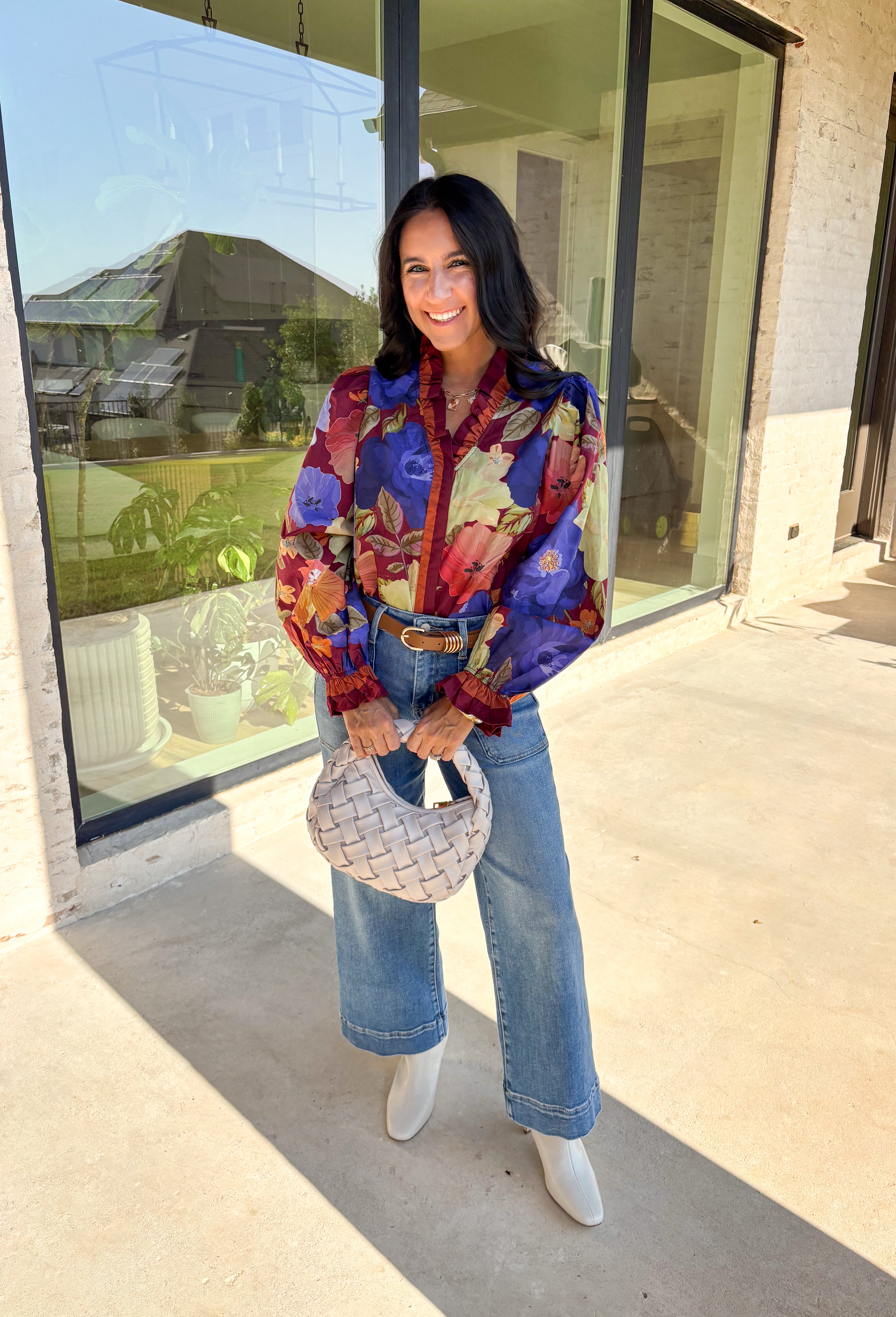 Romantic details make this burgundy floral top a standout for fall. The long sleeves give it an easy, relaxed fit, while the pleated ruffle trim along the neckline and placket adds movement and charm. Designed with a mix of autumn tones in the print, it’s a lightweight piece that’s as versatile as it is stylish. Perfect for workdays, casual weekends, or seasonal gatherings, this blouse transitions seamlessly from day to night.