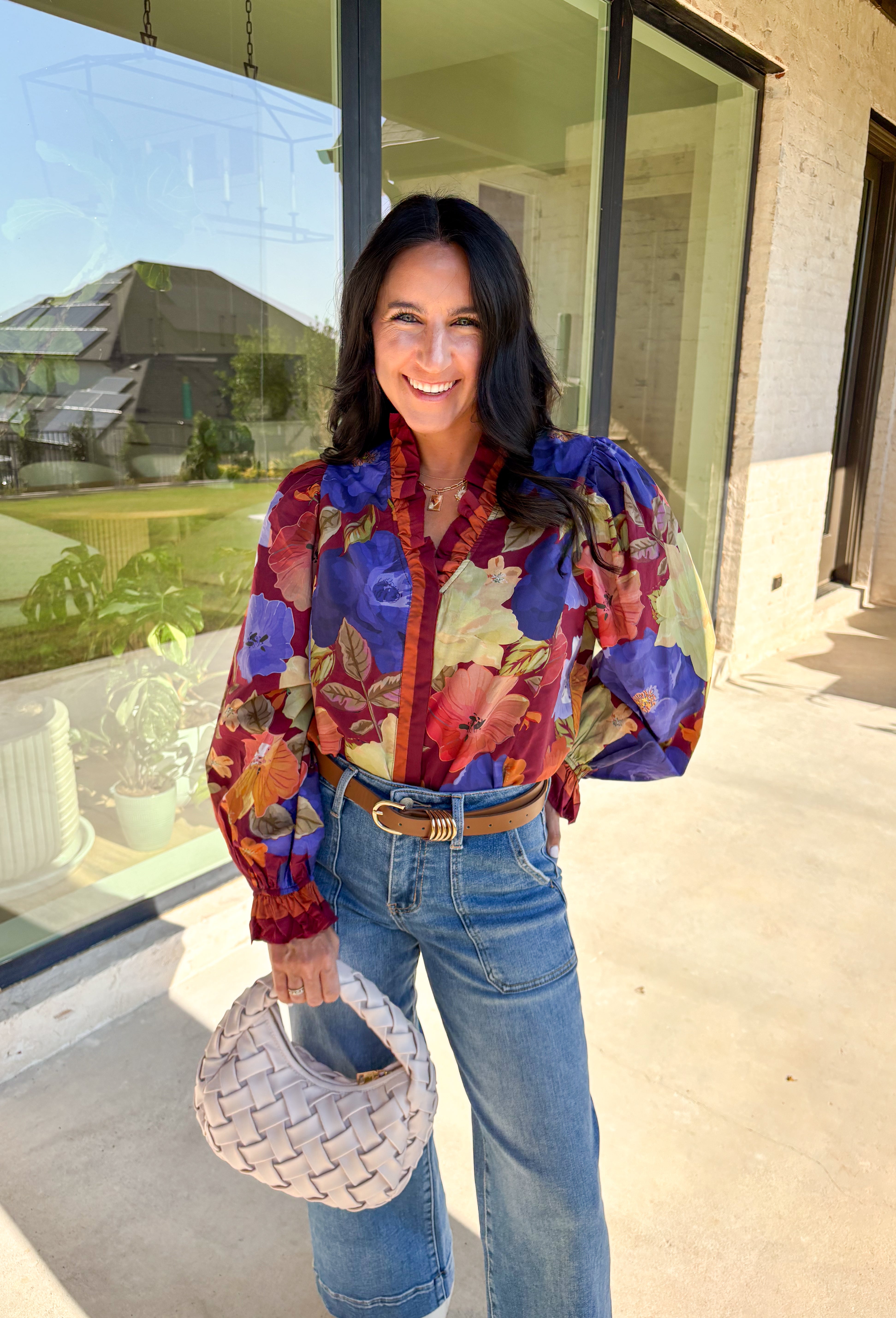 Romantic details make this burgundy floral top a standout for fall. The long sleeves give it an easy, relaxed fit, while the pleated ruffle trim along the neckline and placket adds movement and charm. Designed with a mix of autumn tones in the print, it’s a lightweight piece that’s as versatile as it is stylish. Perfect for workdays, casual weekends, or seasonal gatherings, this blouse transitions seamlessly from day to night.