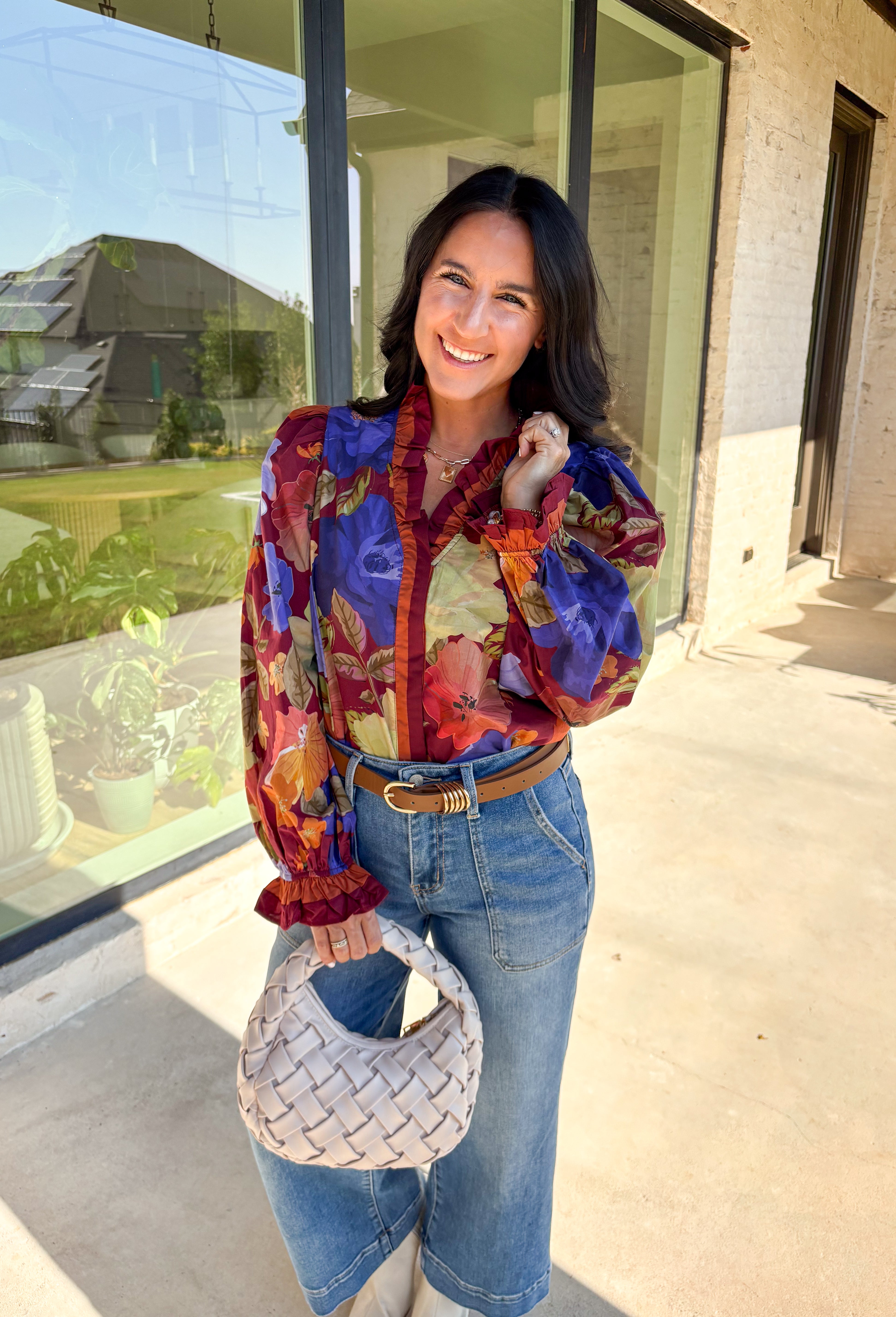 Romantic details make this burgundy floral top a standout for fall. The long sleeves give it an easy, relaxed fit, while the pleated ruffle trim along the neckline and placket adds movement and charm. Designed with a mix of autumn tones in the print, it’s a lightweight piece that’s as versatile as it is stylish. Perfect for workdays, casual weekends, or seasonal gatherings, this blouse transitions seamlessly from day to night.