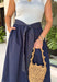 This sleeveless midi dress is the definition of effortless summer style! With its white top and navy skirt design, it gives you that perfectly layered look without any extra effort. The self-tie belt with white threading detail adds a flattering touch at the waist, while the matching detail along the hem pulls everything together beautifully. Lightweight, lined, and finished with side pockets, it’s as practical as it is polished. 
