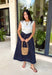 This sleeveless midi dress is the definition of effortless summer style! With its white top and navy skirt design, it gives you that perfectly layered look without any extra effort. The self-tie belt with white threading detail adds a flattering touch at the waist, while the matching detail along the hem pulls everything together beautifully. Lightweight, lined, and finished with side pockets, it’s as practical as it is polished. 