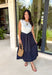 This sleeveless midi dress is the definition of effortless summer style! With its white top and navy skirt design, it gives you that perfectly layered look without any extra effort. The self-tie belt with white threading detail adds a flattering touch at the waist, while the matching detail along the hem pulls everything together beautifully. Lightweight, lined, and finished with side pockets, it’s as practical as it is polished. 