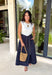This sleeveless midi dress is the definition of effortless summer style! With its white top and navy skirt design, it gives you that perfectly layered look without any extra effort. The self-tie belt with white threading detail adds a flattering touch at the waist, while the matching detail along the hem pulls everything together beautifully. Lightweight, lined, and finished with side pockets, it’s as practical as it is polished. 