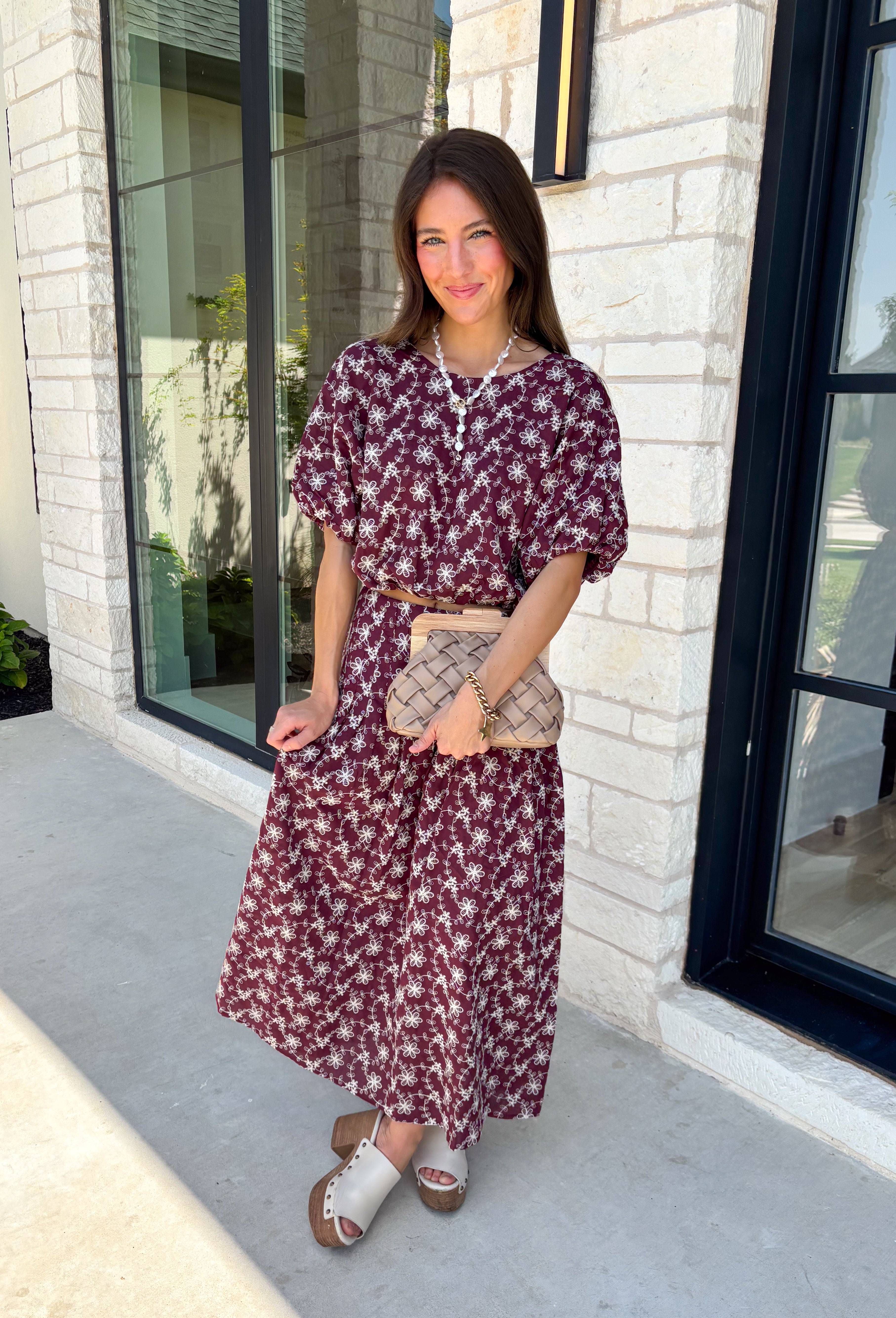 Effortlessly coordinated and beautifully feminine, this matching set is made for all your favorite fall occasions! Featuring a rich maroon hue with delicate off white floral embroidery, this two-piece outfit makes getting dressed easy while still looking polished. The short sleeve top is finished with a comfortable elastic hem, while the coordinating midi skirt features an elastic waistband for an easy, flattering fit. 