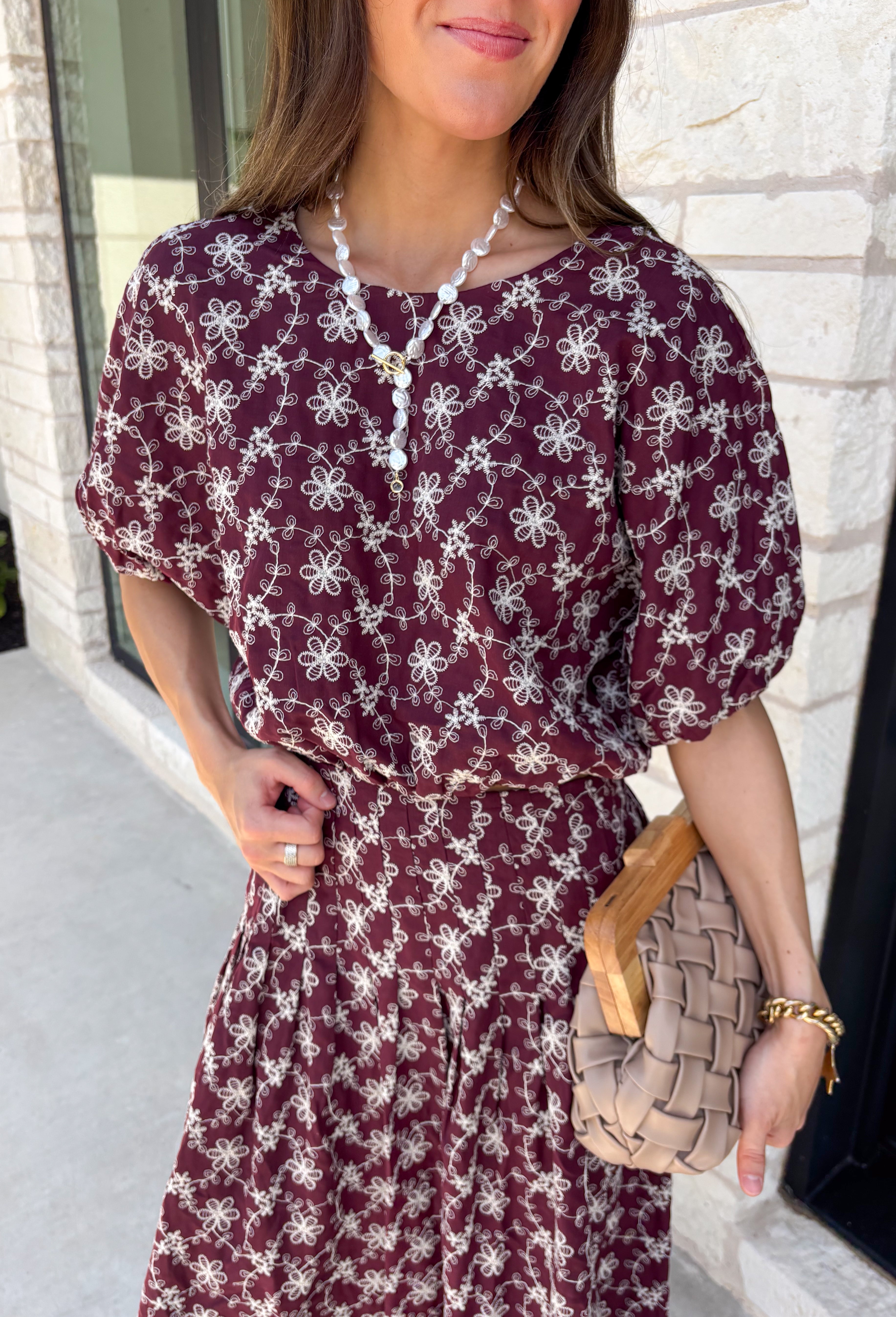 Effortlessly coordinated and beautifully feminine, this matching set is made for all your favorite fall occasions! Featuring a rich maroon hue with delicate off white floral embroidery, this two-piece outfit makes getting dressed easy while still looking polished. The short sleeve top is finished with a comfortable elastic hem, while the coordinating midi skirt features an elastic waistband for an easy, flattering fit. 