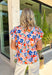 This colorful floral top is pure sunshine in clothing form! With its bright, happy print, it instantly lifts your whole outfit and mood. The blue and white trim along the neckline adds a fun contrast detail, while the puff sleeves give it that soft, feminine shape that’s so easy to wear. Lightweight with a comfortable stretch, it’s perfect for warm days when you want something cheerful and effortless. 