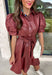 Make a statement this fall in this stunning dusty rose faux leather dress. The rich faux leather finish brings an elevated touch, while the feminine details keep the look soft and timeless. Featuring delicate floral eyelet sleeves with puff shoulders, a flattering self-tie waist, and a classic collared neckline, this dress perfectly blends sophistication with everyday wearability. 