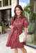 Make a statement this fall in this stunning dusty rose faux leather dress. The rich faux leather finish brings an elevated touch, while the feminine details keep the look soft and timeless. Featuring delicate floral eyelet sleeves with puff shoulders, a flattering self-tie waist, and a classic collared neckline, this dress perfectly blends sophistication with everyday wearability. 