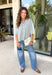 This light grey cardigan is the perfect layering piece for the season ahead! The soft knit and timeless button down design make it a wardrobe staple you'll reach for again and again. A crisp white stripe along the sleeves adds a subtle varsity-inspired touch, while the ribbed hem and sleeve cuffs create a polished finish. Wear it buttoned as a sweater or layered over your favorite basics for endless styling possibilities.
