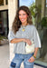 This light grey cardigan is the perfect layering piece for the season ahead! The soft knit and timeless button down design make it a wardrobe staple you'll reach for again and again. A crisp white stripe along the sleeves adds a subtle varsity-inspired touch, while the ribbed hem and sleeve cuffs create a polished finish. Wear it buttoned as a sweater or layered over your favorite basics for endless styling possibilities.