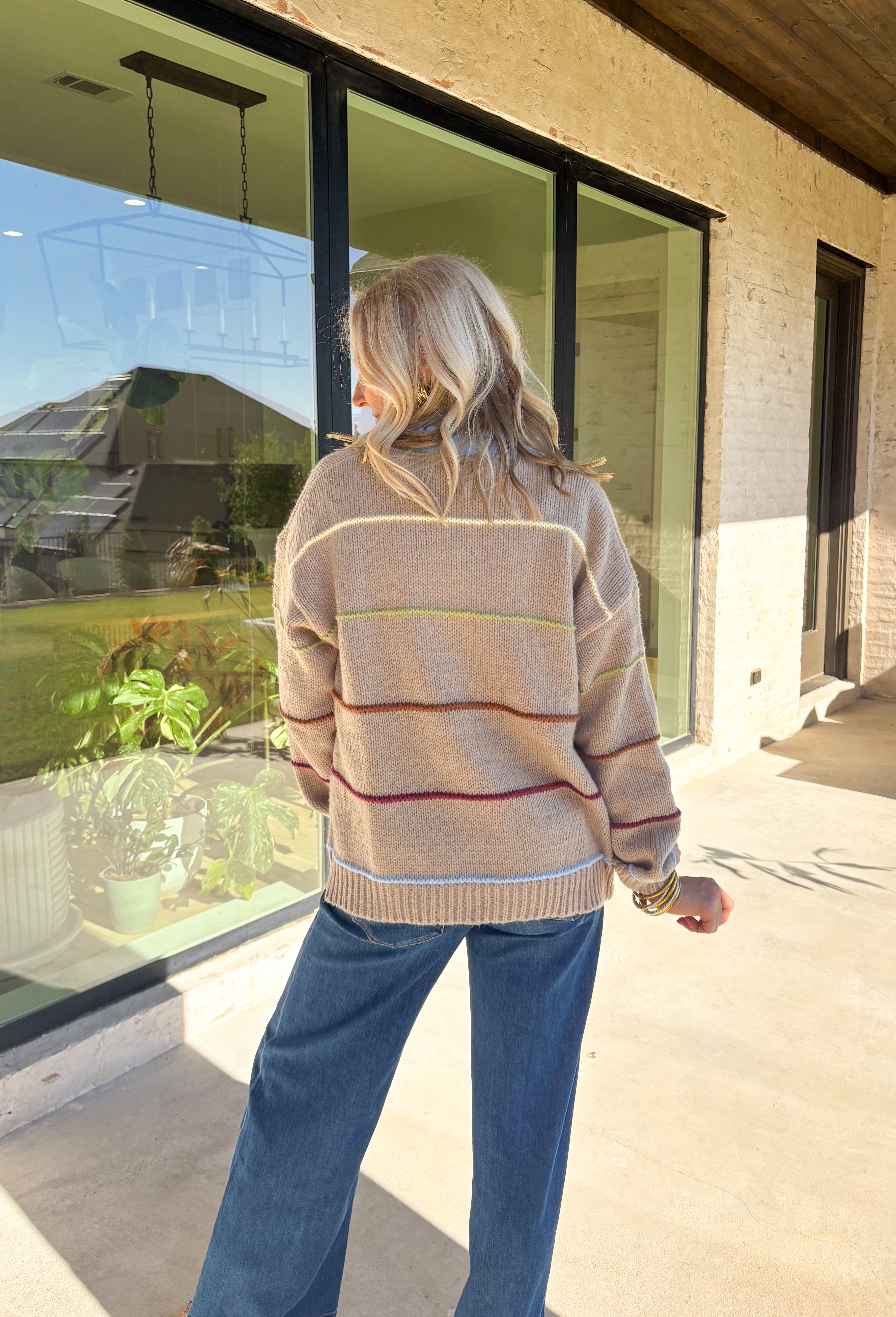 Cozy, colorful, and perfect for layering—this tan knit cardigan is a must-have for your fall wardrobe. Designed with bold stripes in burgundy, brown, green, light yellow, and light blue, it’s finished with light blue trim along the neckline and edges for a playful pop. The soft knit makes it warm without being heavy, giving you the ideal piece to throw over basics or style with denim and dresses alike.