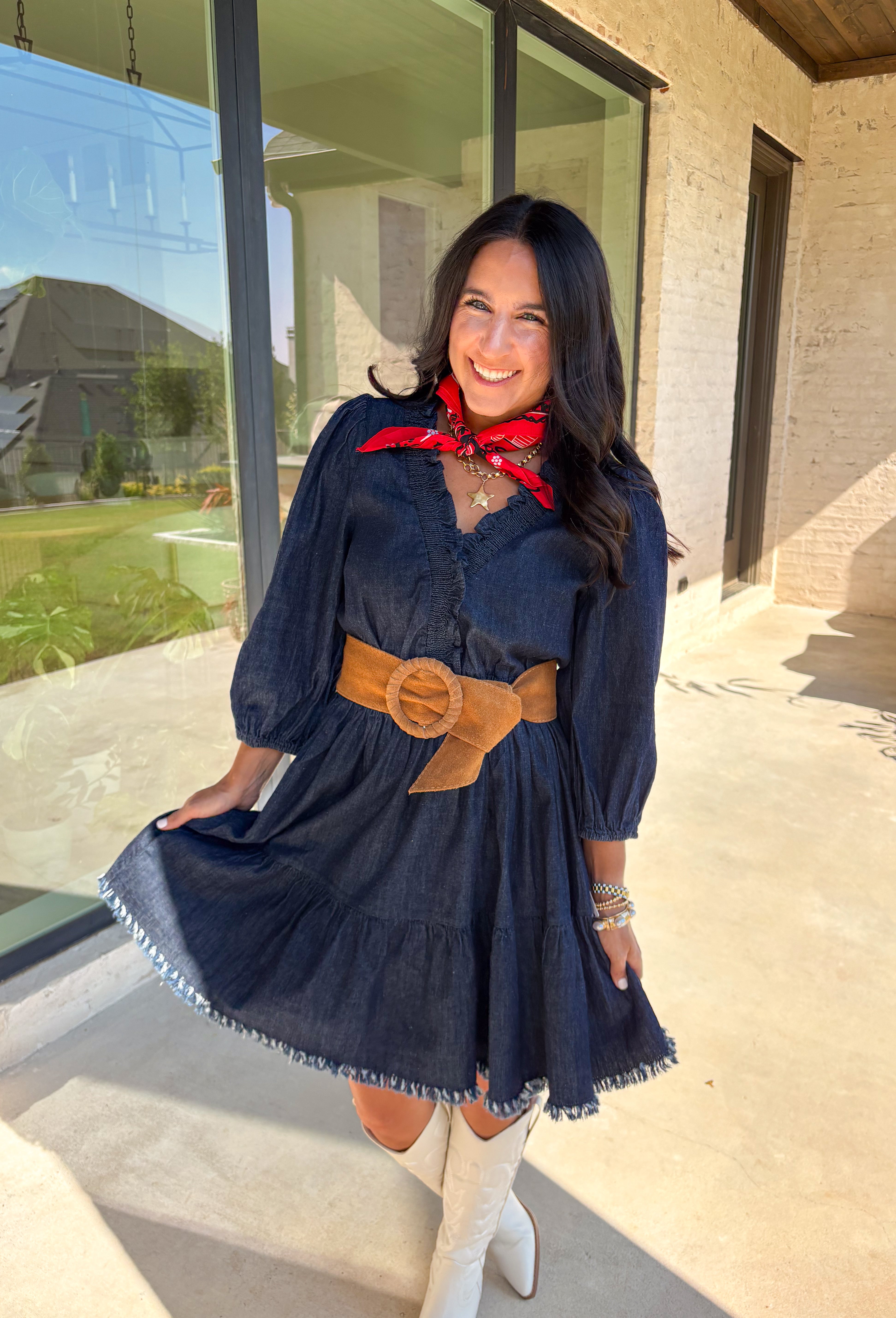 Denim with a feminine twist—this long sleeve dress is a seasonal must-have. Designed in a rich dark wash, it features a flattering smocked waist and a raw edge hem that adds a casual, lived-in feel. The ruffle trim softens the look, while elastic cuff sleeves keep it comfortable and easy to wear. Made from a cotton blend, it’s lightweight enough to layer and cozy enough to wear on its own for crisp fall days.