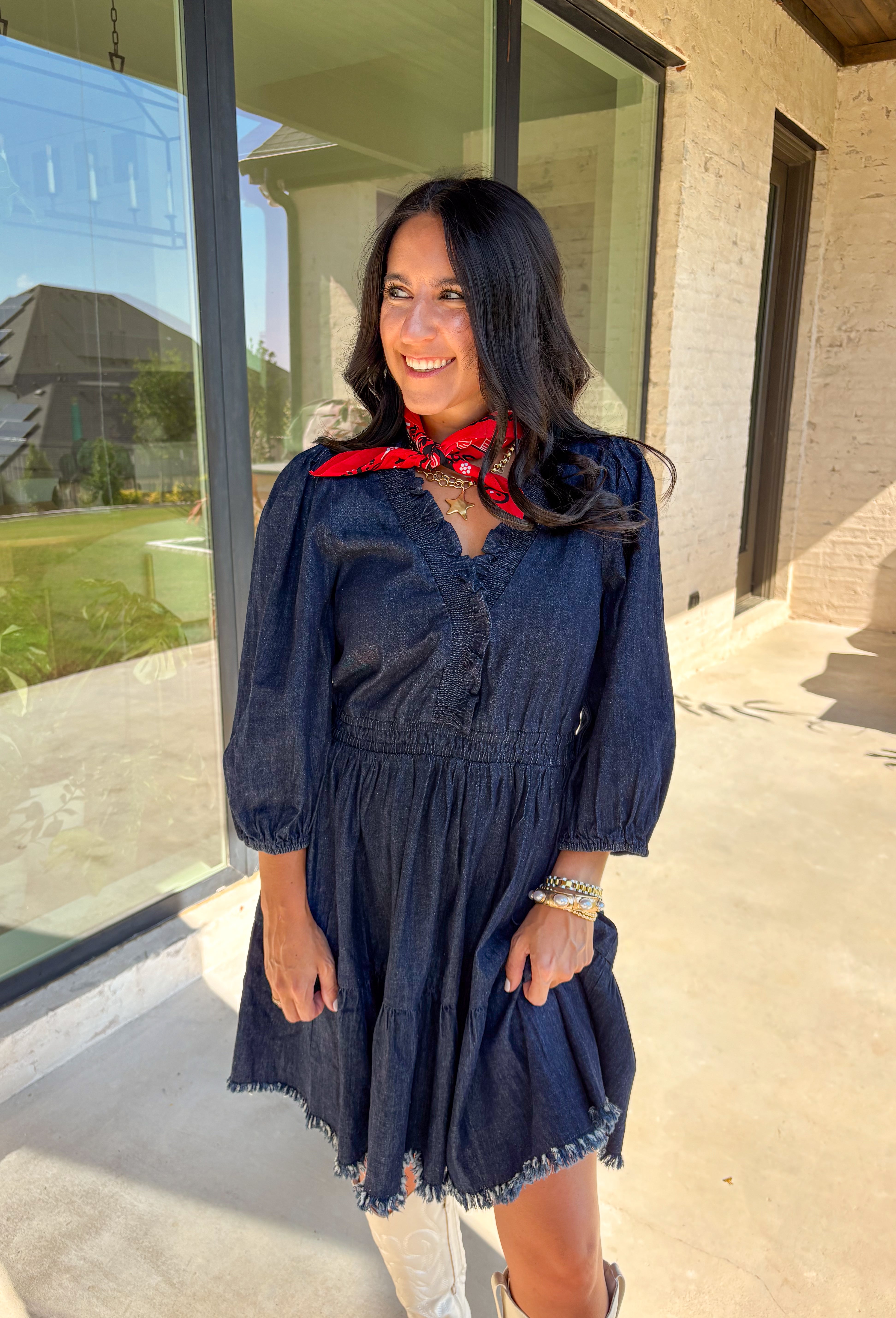 Denim with a feminine twist—this long sleeve dress is a seasonal must-have. Designed in a rich dark wash, it features a flattering smocked waist and a raw edge hem that adds a casual, lived-in feel. The ruffle trim softens the look, while elastic cuff sleeves keep it comfortable and easy to wear. Made from a cotton blend, it’s lightweight enough to layer and cozy enough to wear on its own for crisp fall days.