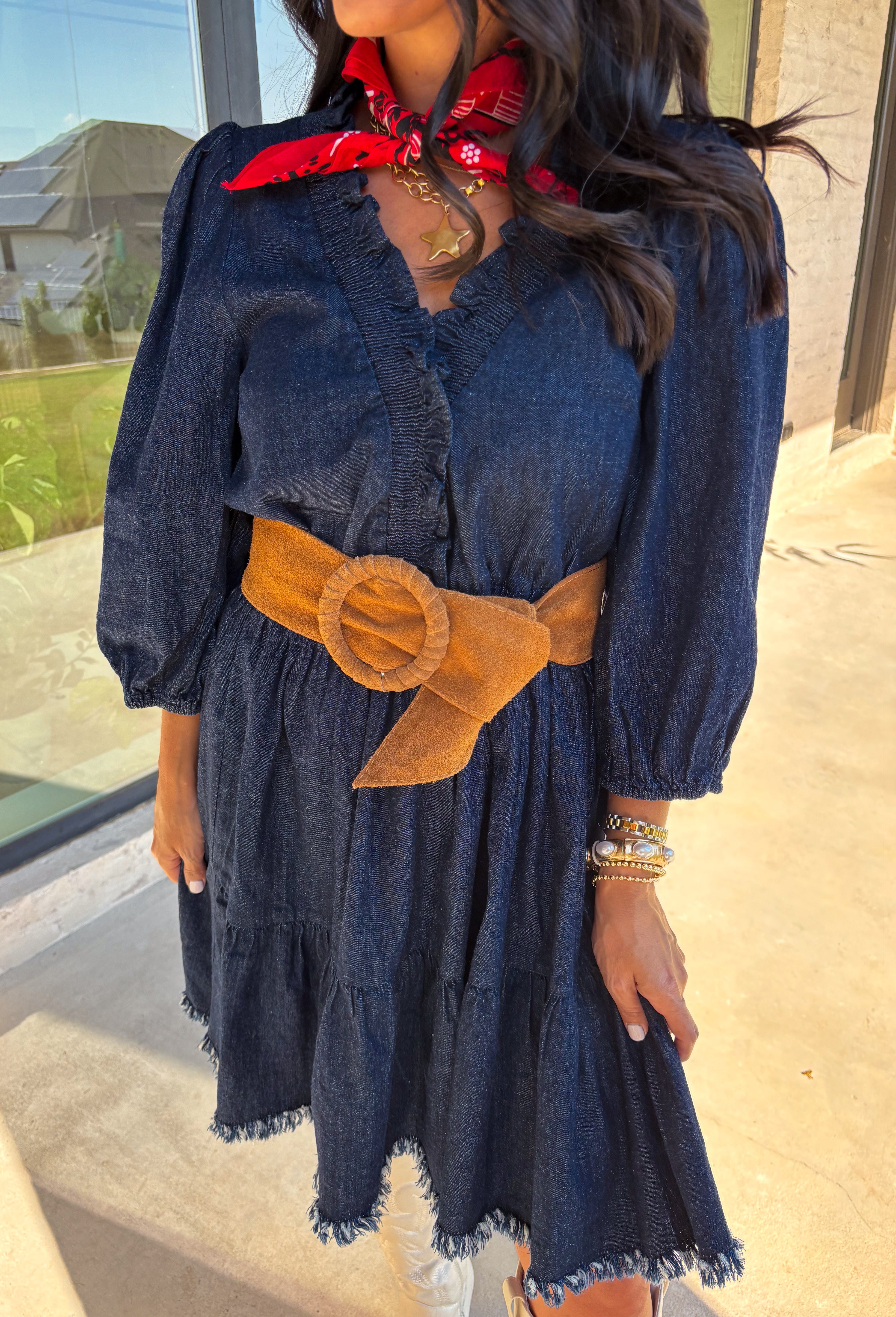 Denim with a feminine twist—this long sleeve dress is a seasonal must-have. Designed in a rich dark wash, it features a flattering smocked waist and a raw edge hem that adds a casual, lived-in feel. The ruffle trim softens the look, while elastic cuff sleeves keep it comfortable and easy to wear. Made from a cotton blend, it’s lightweight enough to layer and cozy enough to wear on its own for crisp fall days.